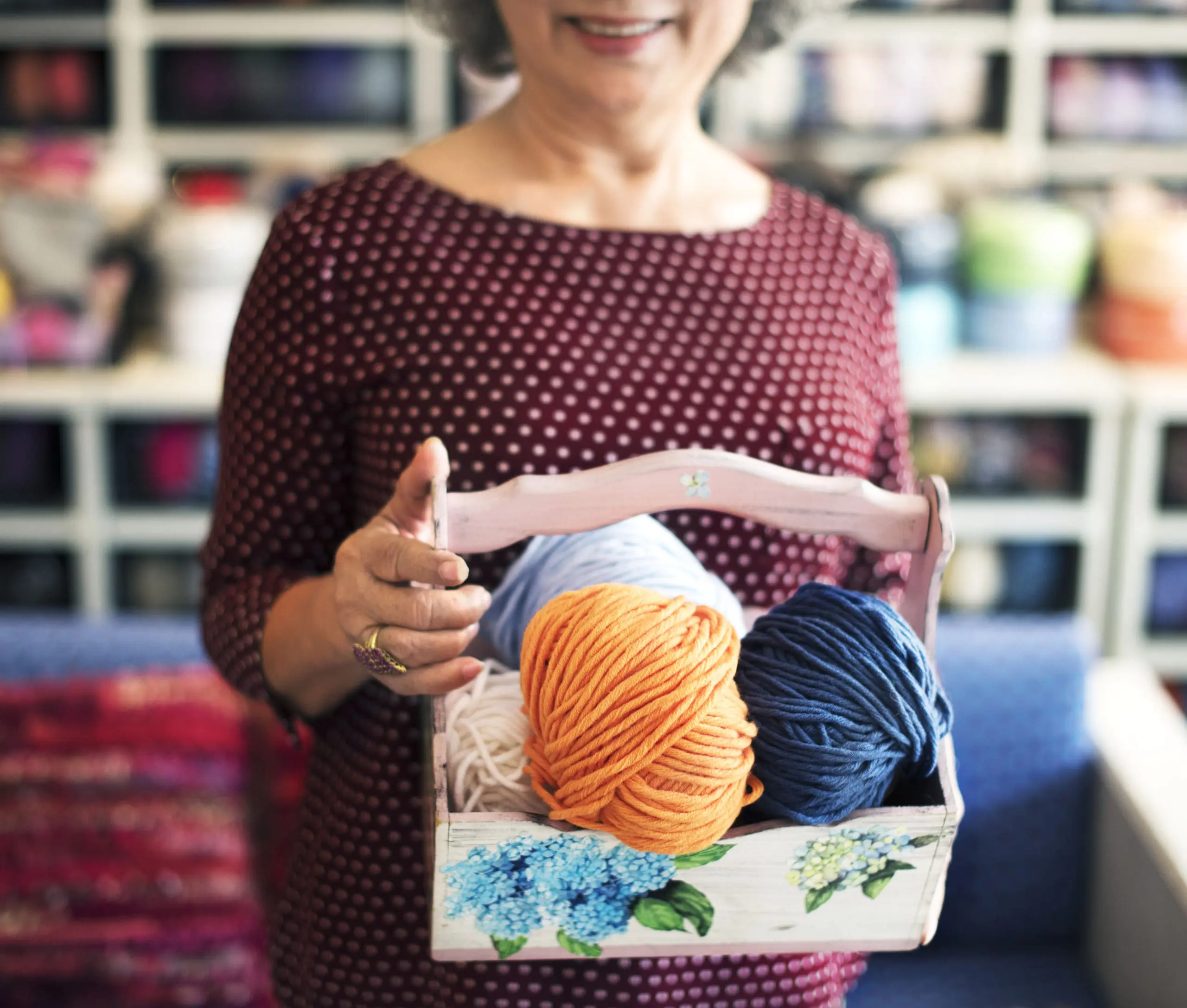 Woman holding a basket of yarn